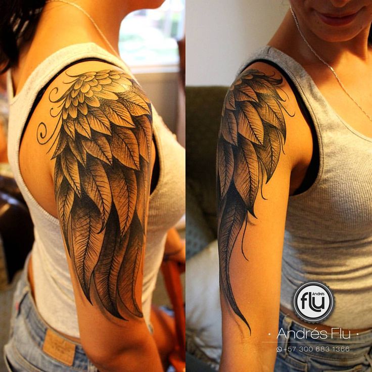 a woman's arm with an angel wing tattoo on the left side of her shoulder