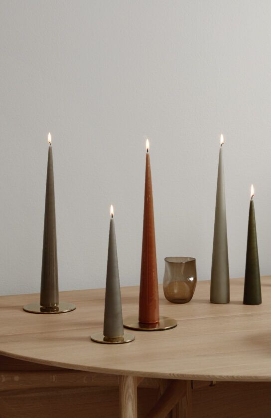 five candles are lined up on a table