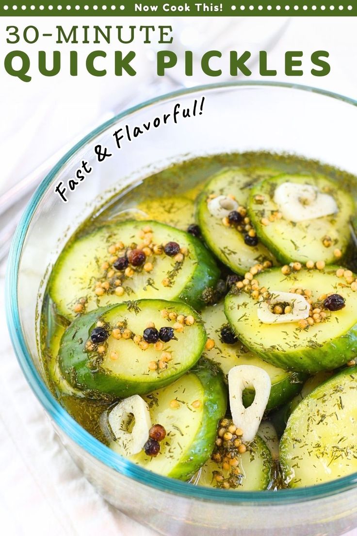 a glass bowl filled with sliced cucumbers and spices