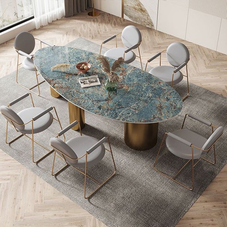 a dining table with chairs around it and a rug on the floor next to it