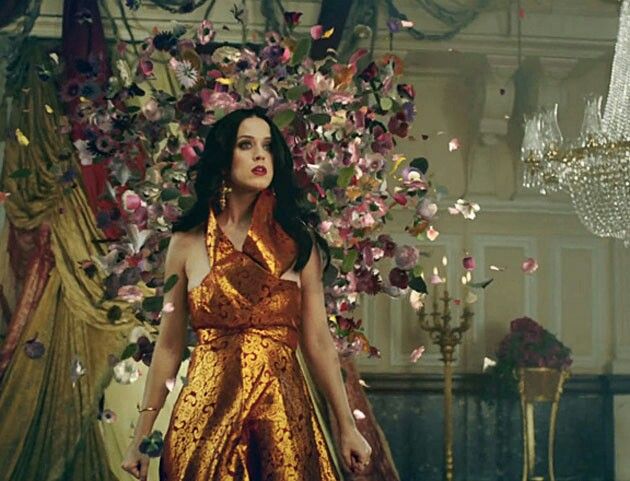 a woman standing in front of a chandelier