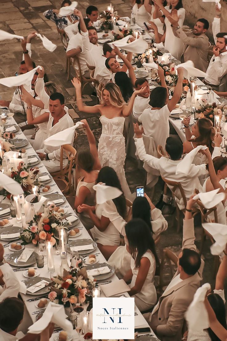 a large group of people sitting at tables with plates and napkins in front of them