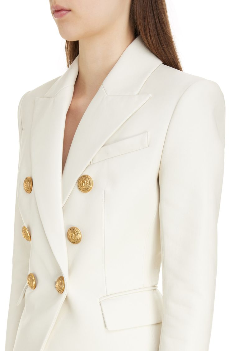 Golden lion-embossed buttons add signature embellishment to the front of a double-breasted leather blazer tailored with sharp shoulders and peaked lapels. 25" length (size 40) Double-breasted button closure Peaked lapels Five-button cuffs Chest welt pocket; front flap pockets Lined Leather Professional leather clean Imported Designer Clothing