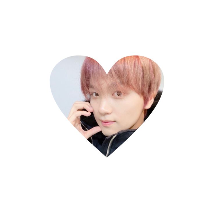 a man with pink hair talking on a cell phone in front of a heart shaped photo