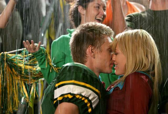 a man and woman kissing in the rain