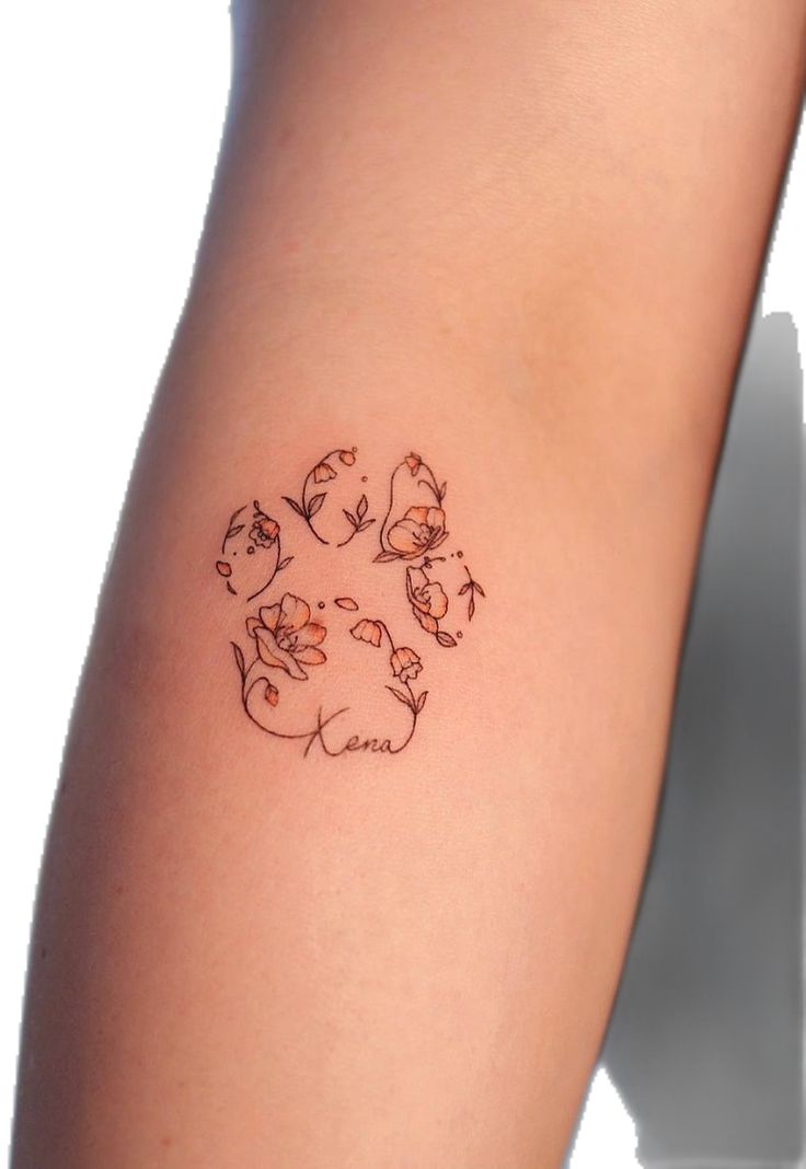 a woman's arm with a tattoo on it that has cats in the middle