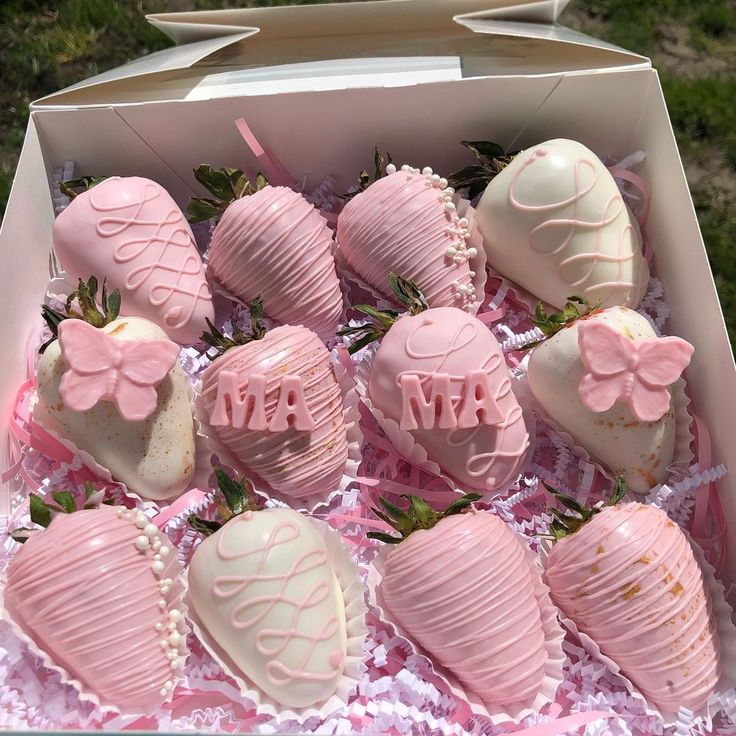 a box filled with pink chocolate covered strawberries