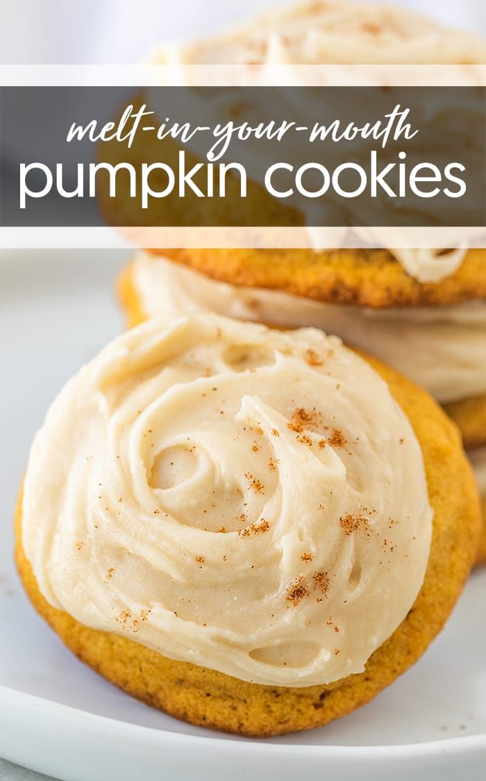 three pumpkin cookies with frosting on a white plate