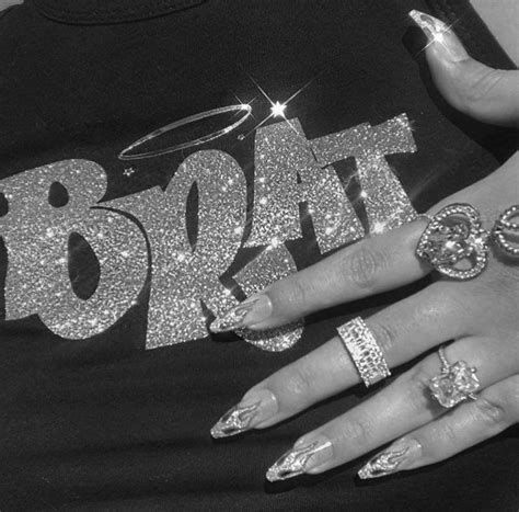 a black and white photo of a woman's hands with rings on them