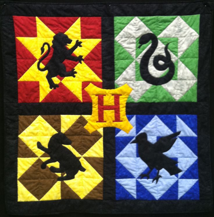 a quilt with animals and letters on it