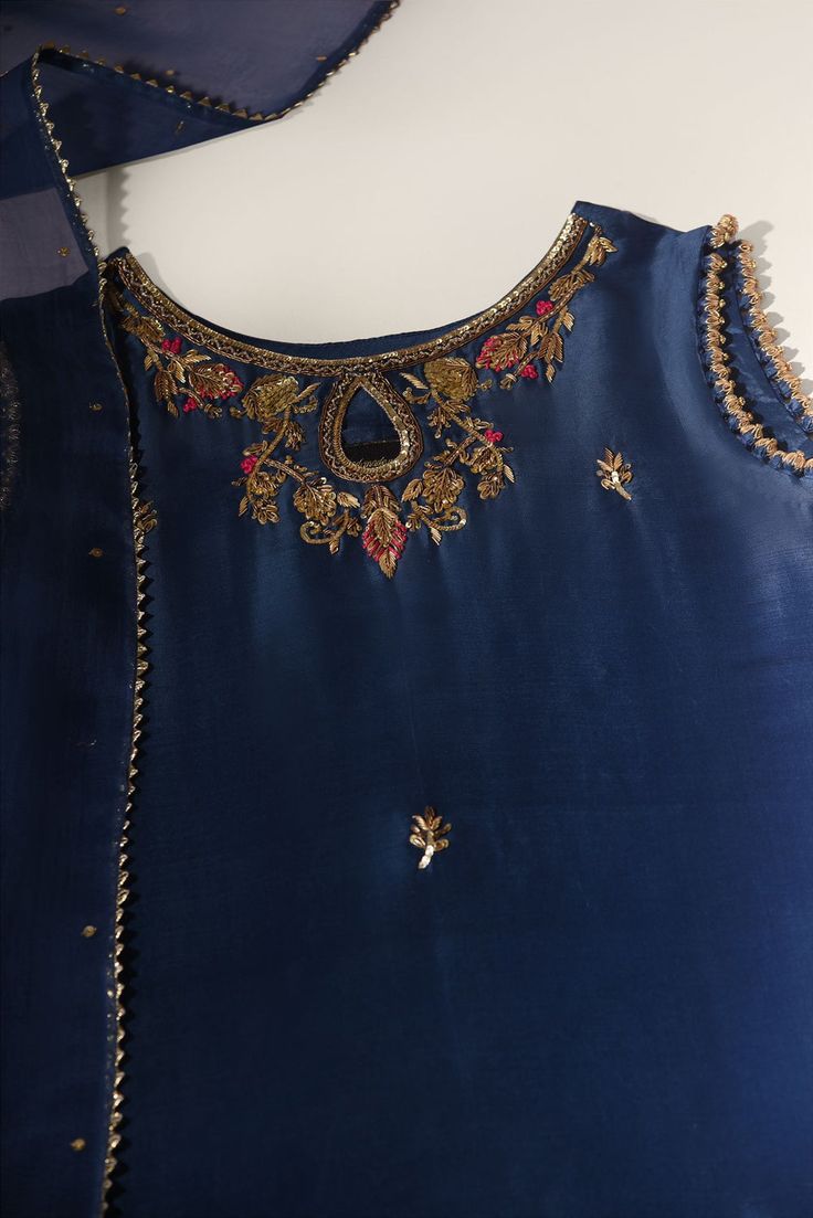 Meticulously designed on pure navy blue raw silk 60 gms, with its intricate hand crafted details strikes the perfect balance between elegant and eye-catching, making this beautiful design a must have. The length of the long kameez is 40 inches. Styled with matching flappers and embellished dupatta. Order Duration: 4 to Blue Silk Kurta With Dori Work, Festive Blue Slub Silk Salwar Kameez, Blue Raw Silk Anarkali Set For Diwali, Blue Bollywood Style Salwar Kameez In Slub Silk, Indigo Salwar Kameez With Resham Embroidery, Indigo Chanderi Salwar Kameez With Zari Work, Designer Blue Silk Sharara, Elegant Churidar With Dori Work In Slub Silk, Elegant Slub Silk Churidar With Dori Work