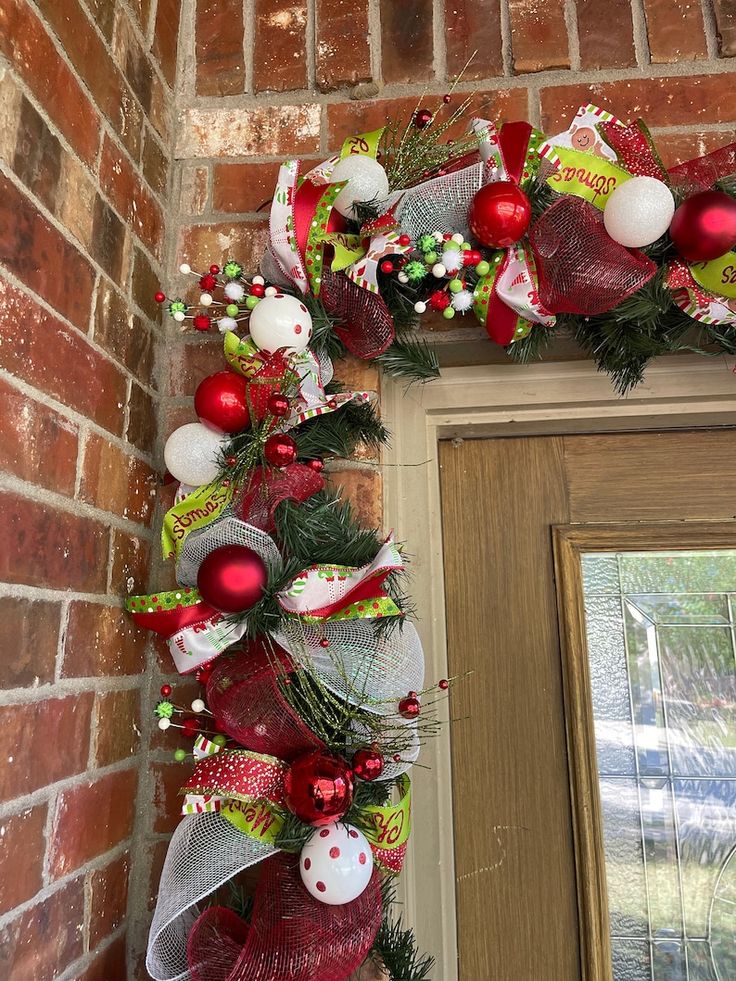 a christmas wreath is hanging on the front door