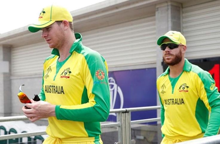 two men in yellow and green uniforms standing next to each other