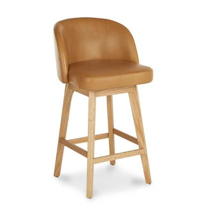 a brown leather bar stool with wooden legs