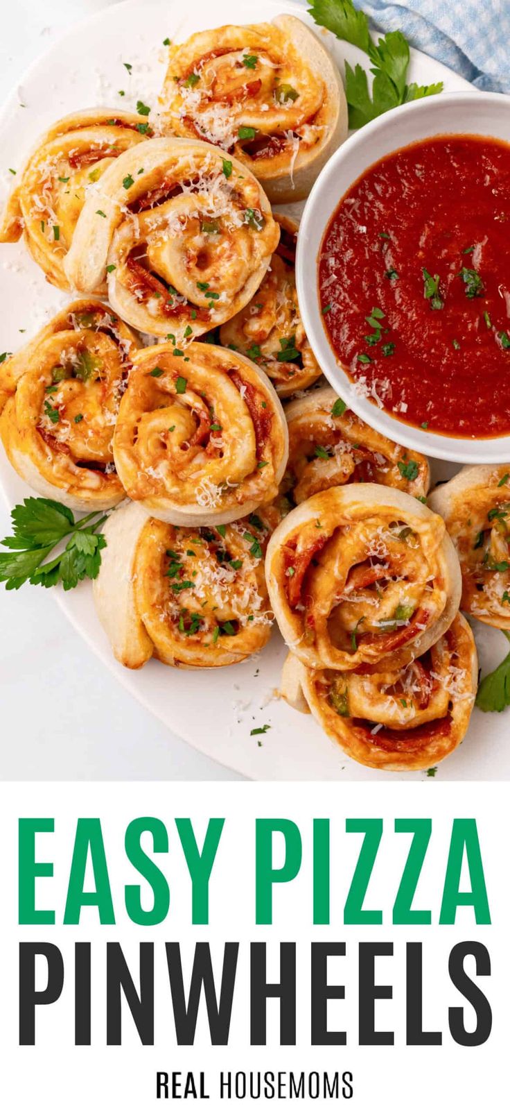 easy pizza pinwheels on a white plate with red sauce