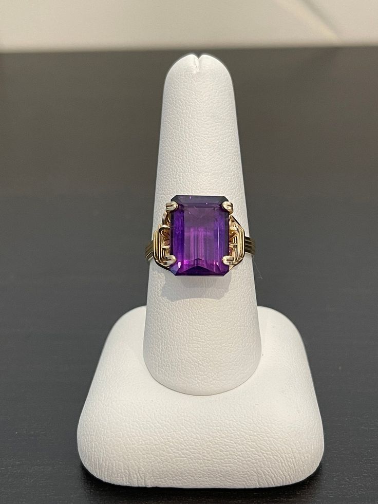 The wire-wrapping on this gold-filled ring is superb, an extremely talented artist crafted this. The synthetic purple stone is gorgeous; grape purple and 14 x 10 mm. This ring is a size 8 1/2. Formal Purple Rings With Rectangular Stone, Formal Purple Open Ring Jewelry, Purple Open Ring Formal Jewelry, Elegant Adjustable Gold Amethyst Ring, Purple Gemstone Ring With Rectangular Stone, Fine Jewelry With Rectangular Purple Stone, 14k Gold Purple Ring Jewelry, Elegant Adjustable Amethyst Gold Ring, Gold Rectangular Amethyst Ring