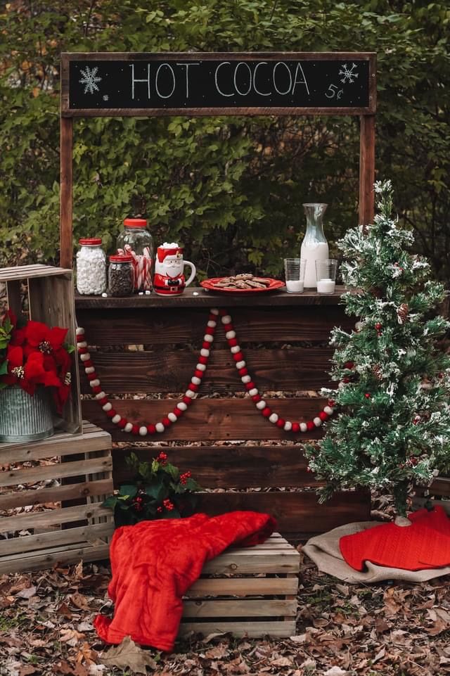 an outdoor hot cocoa stand with christmas decorations