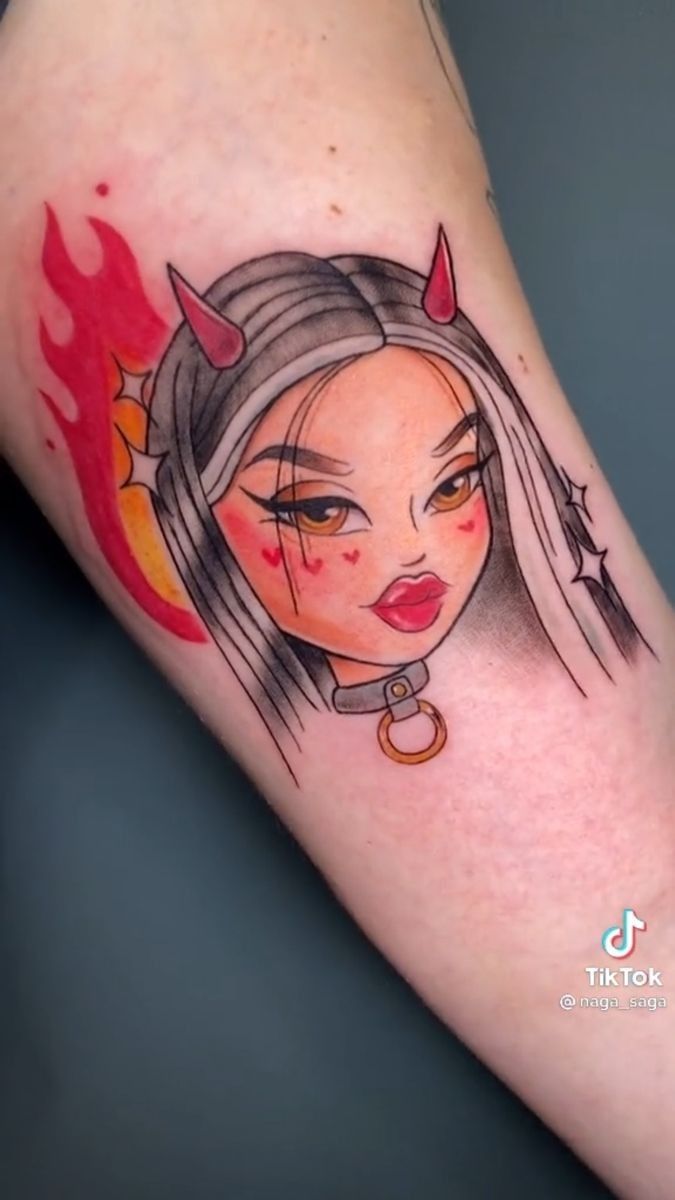 a woman's face with horns and devil horns on her head is shown in this tattoo