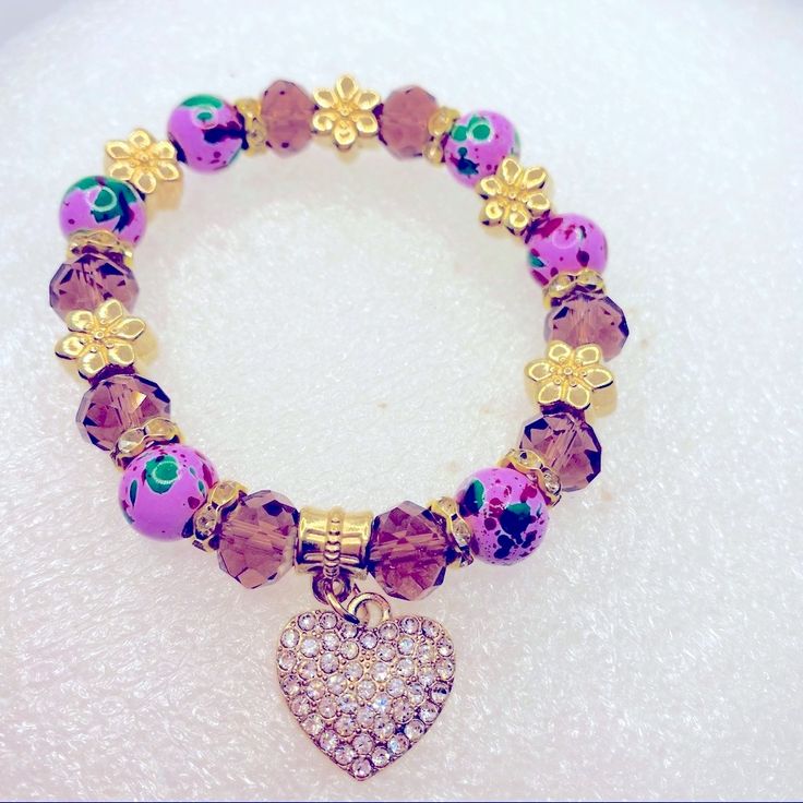 Bracelet Crystal Heart In Purple And Golden.Hand Painted Beads. Very Brilliant! Brand New In Packaging! Very Pretty! Purple Charm Bracelet With Colorful Round Beads, Purple Heart-shaped Beaded Jewelry, Purple Heart Charm Bracelet For Valentine's Day, Adjustable Purple Beaded Bracelets With Heart Beads, Purple Heart Beaded Bracelets, Valentine's Day Purple Bracelet With Heart Charm, Adjustable Purple Jewelry With Heart Charm, Purple Heart Jewelry With Colorful Beads, Purple Heart-shaped Bracelet With Heart Beads