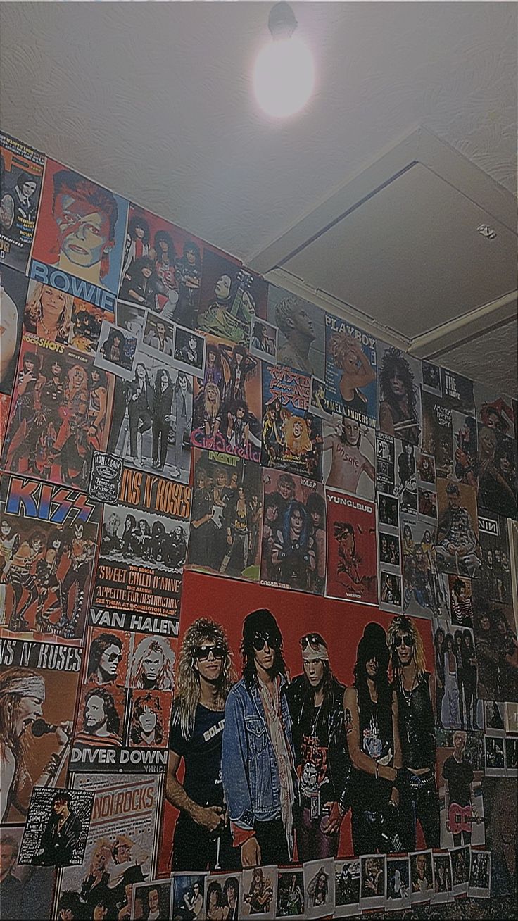 a wall covered with posters and pictures of hard rock bands