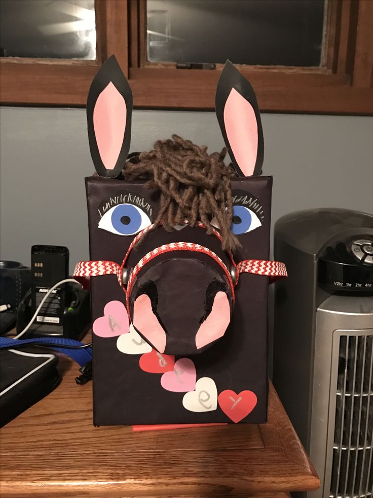 a paper bag with an animal's head on top of it, sitting on a table