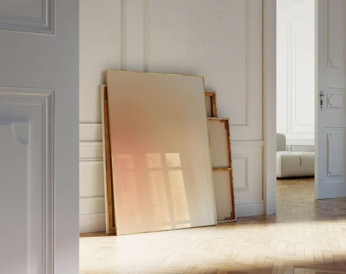 an empty room with white walls and wood flooring is pictured in the foreground