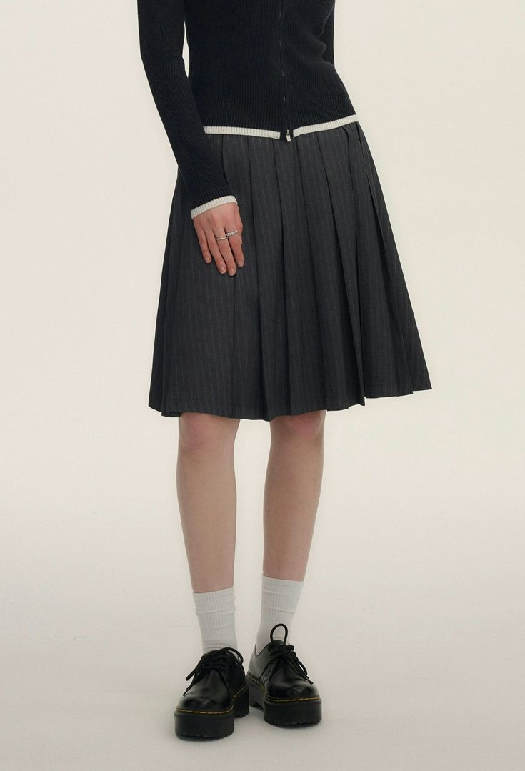 Step into chic sophistication with our Pinstripe Pleated Short-Midi Skirt, a versatile piece tailored to add a touch of moody elegance to your wardrobe.

Crafted with a blend of 70% polyester fiber, 28% viscose, and 2% spandex, this skirt ensures comfort without compromising on style. The classic pinstripe pattern exudes professionalism, while the pleated design adds a playful twist. It's finished with a discreet embroidered logo that subtly elevates the overall aesthetic.

Perfect for transitioning from day to night, pair this skirt with a crisp button-down for business hours or a casual tee for an effortless weekend look. Its A-line cut flatters the natural waist and the length hits just at the knee, making it suitable for various occasions and seasons.

Product specifications:
Material: Chic Striped Lined Skirt Bottoms, Chic Relaxed Skirt With Striped Hem, Chic Skirt With Striped Hem And Relaxed Fit, Striped Knee-length Skirt For Work, Elegant Striped Relaxed Skirt, Pleated Striped Skirt For Work, Striped Pleated Skirt For Work, Relaxed Skirt With Striped Hem, Striped Midi Skirt For Work