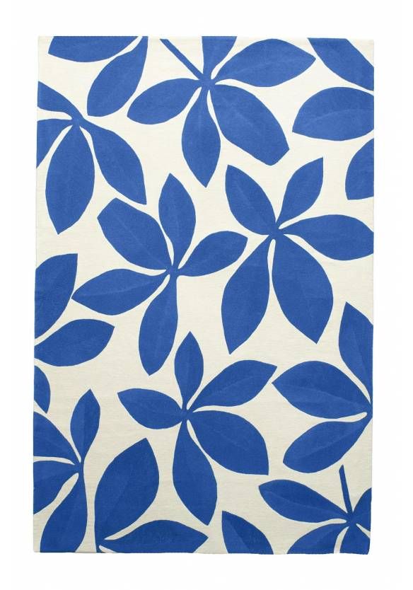 a blue and white rug with large leaves on the bottom, in front of a white background