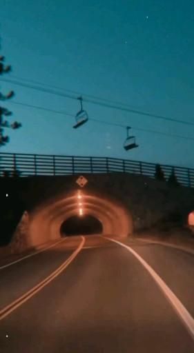 a car driving through a tunnel at night