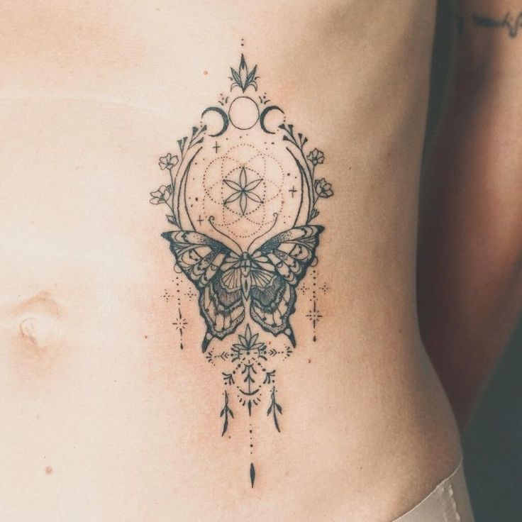 a woman's stomach with a butterfly tattoo on it