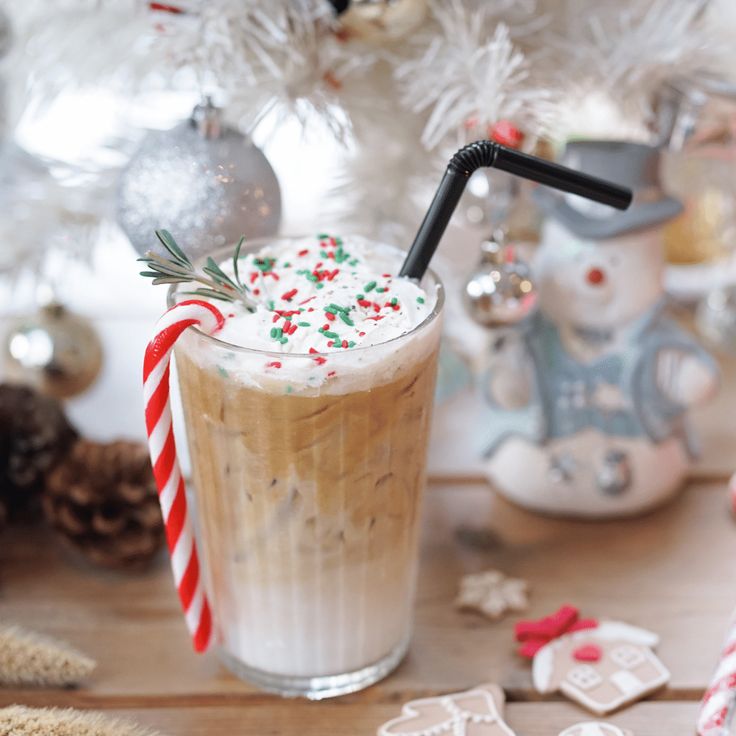 there is a drink on the table with candy canes