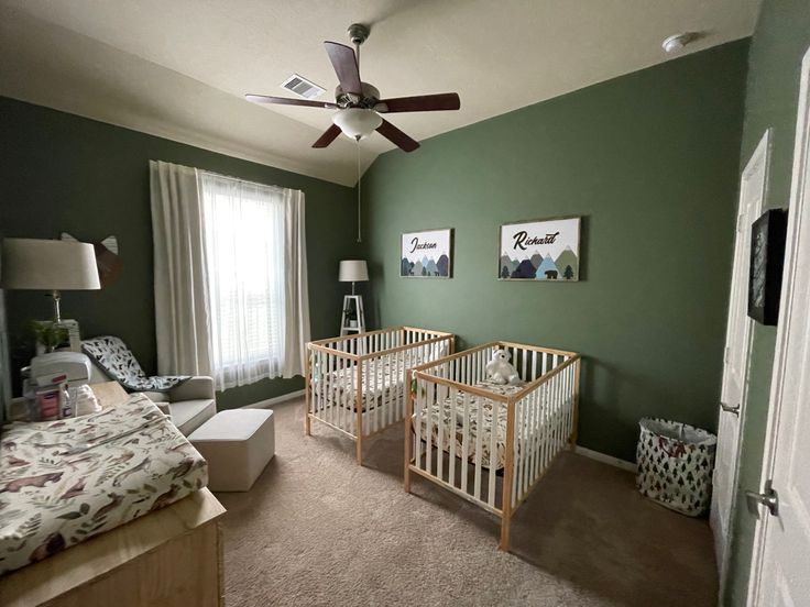 a baby's room with two cribs in it