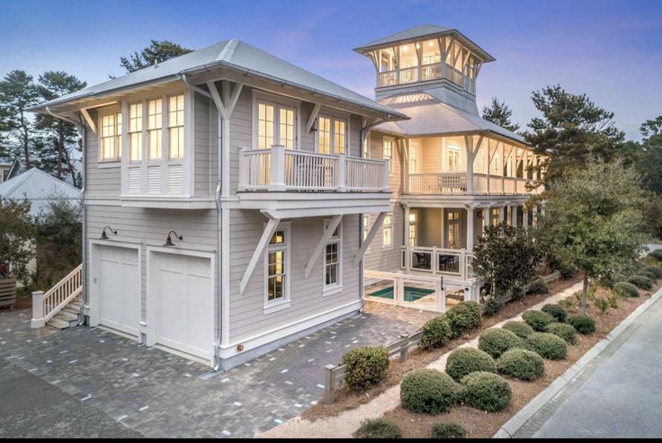 this is an aerial view of a large house in the evening time with lights on