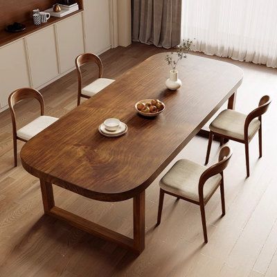 a wooden table with chairs around it