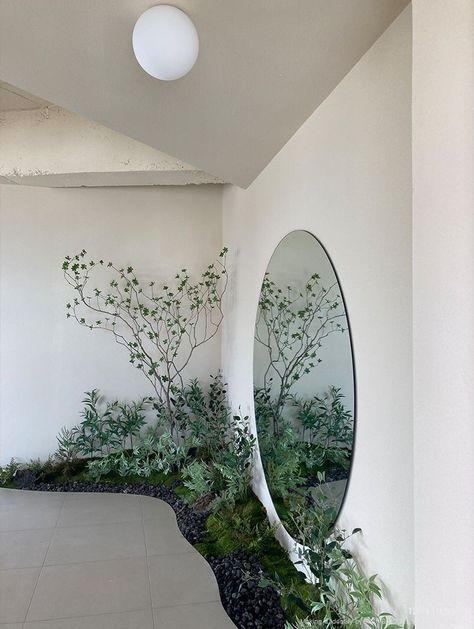 there is a mirror and plants in the room