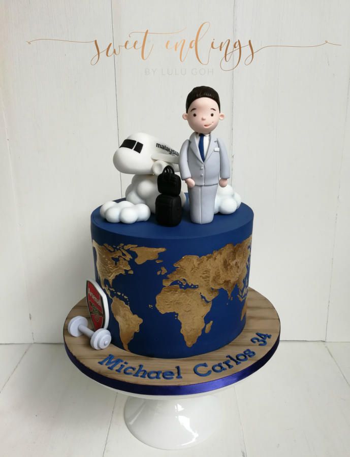 a cake that has a man and dog on it with a world map in the background