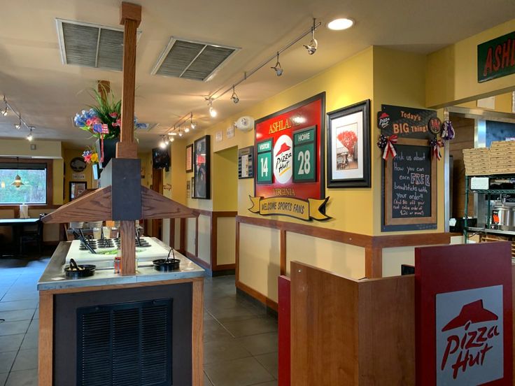 the inside of a fast food restaurant with signs on the wall