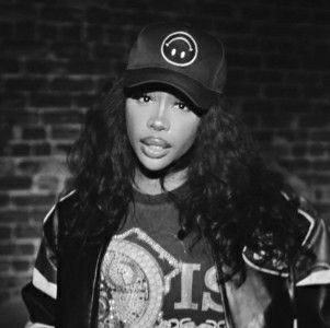 a black and white photo of a woman wearing a hat with the word love on it