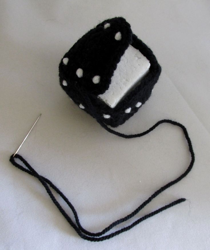 a small black and white object on a string