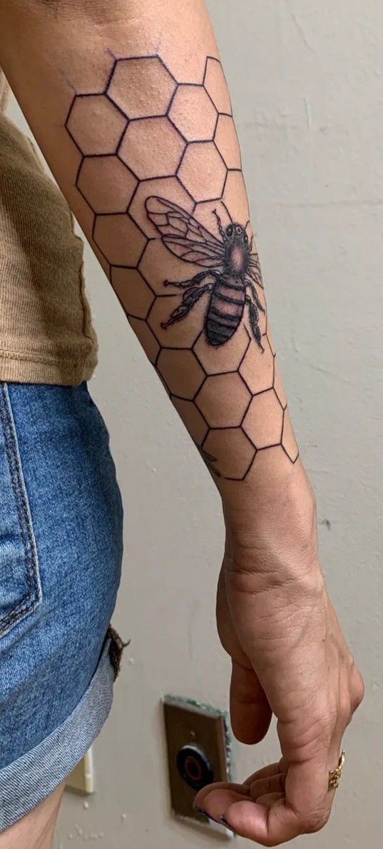 a person with a bee tattoo on their arm