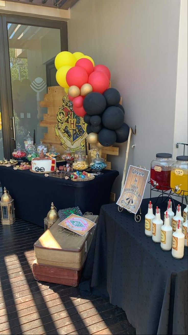 a table topped with lots of balloons and condiments