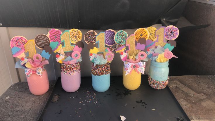 some cupcakes and donuts are in vases