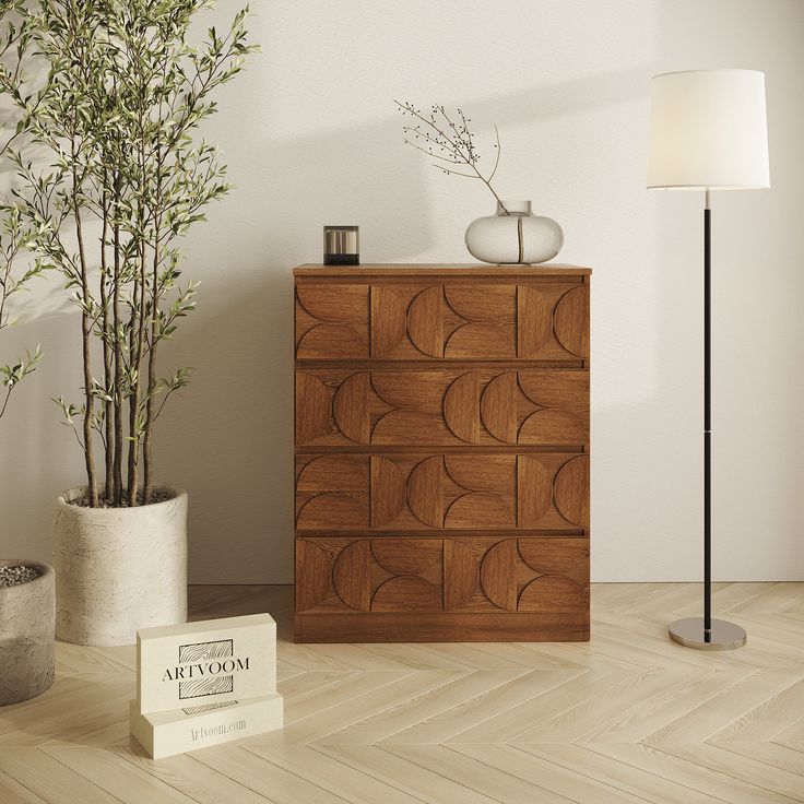 a wooden dresser sitting next to a lamp on top of a hard wood floor