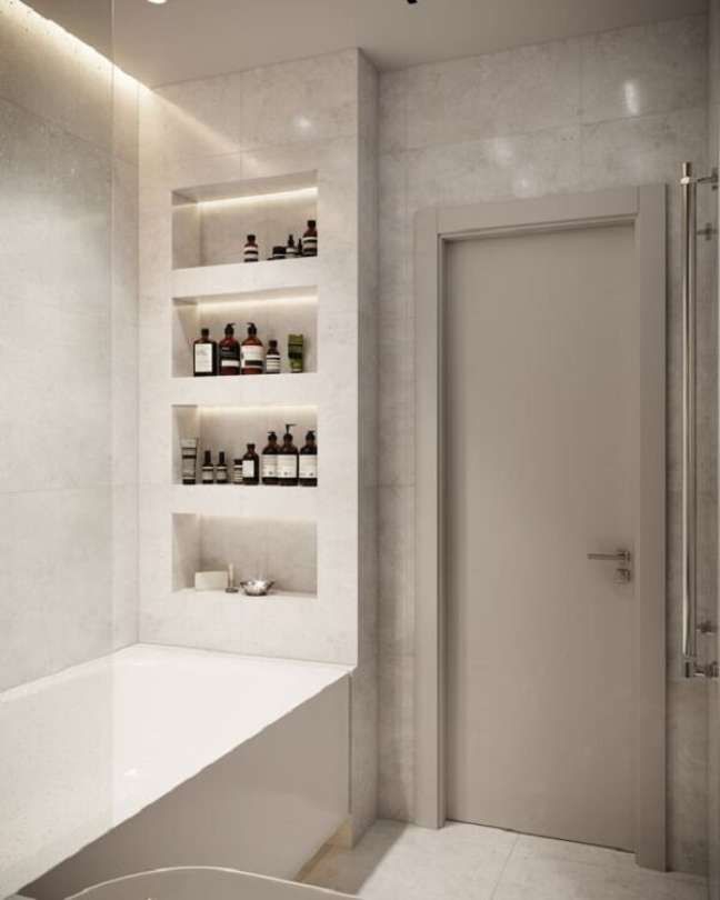 a bathroom with white walls and shelves filled with bottles on the wall next to a bathtub