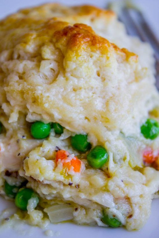 a white plate topped with mashed potatoes and peas