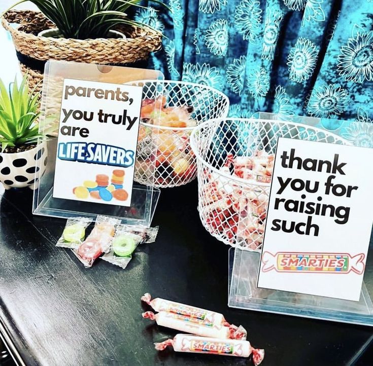 some candy is sitting on a table next to two baskets with signs that say, you truly are friends