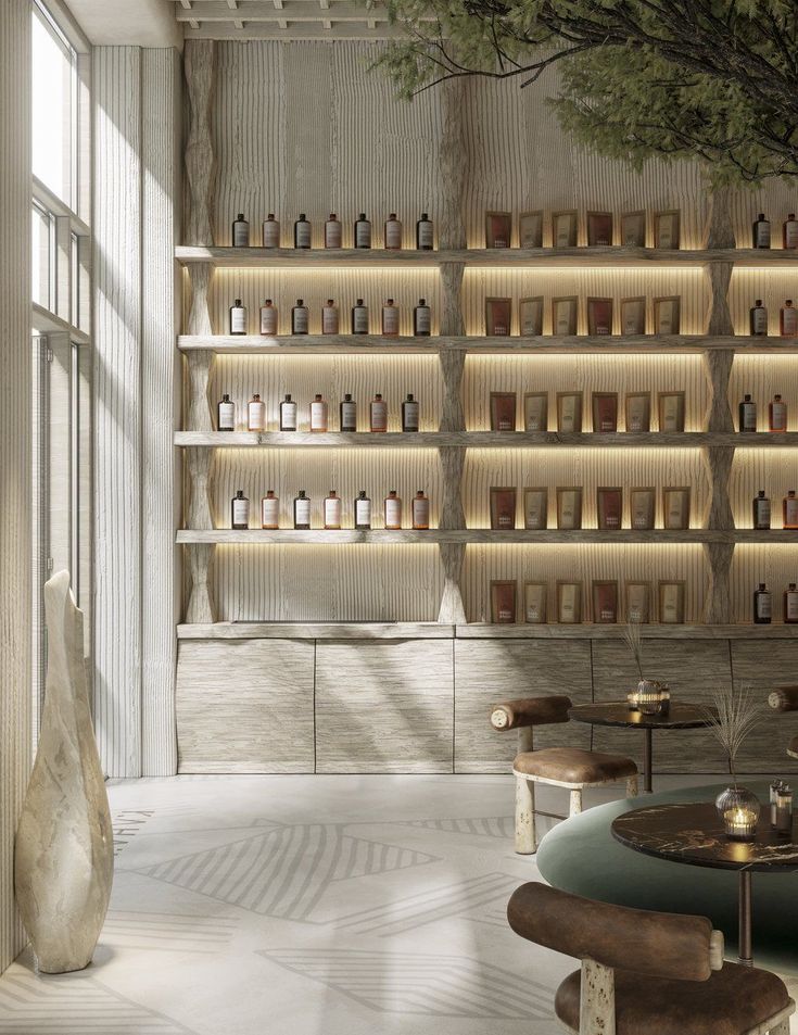 a room with shelves filled with bottles and stools next to a table in front of a window