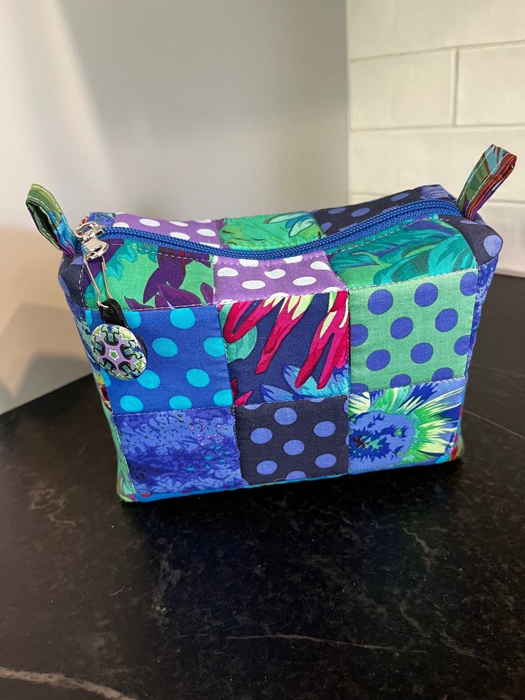 a colorful patchwork bag sitting on top of a counter