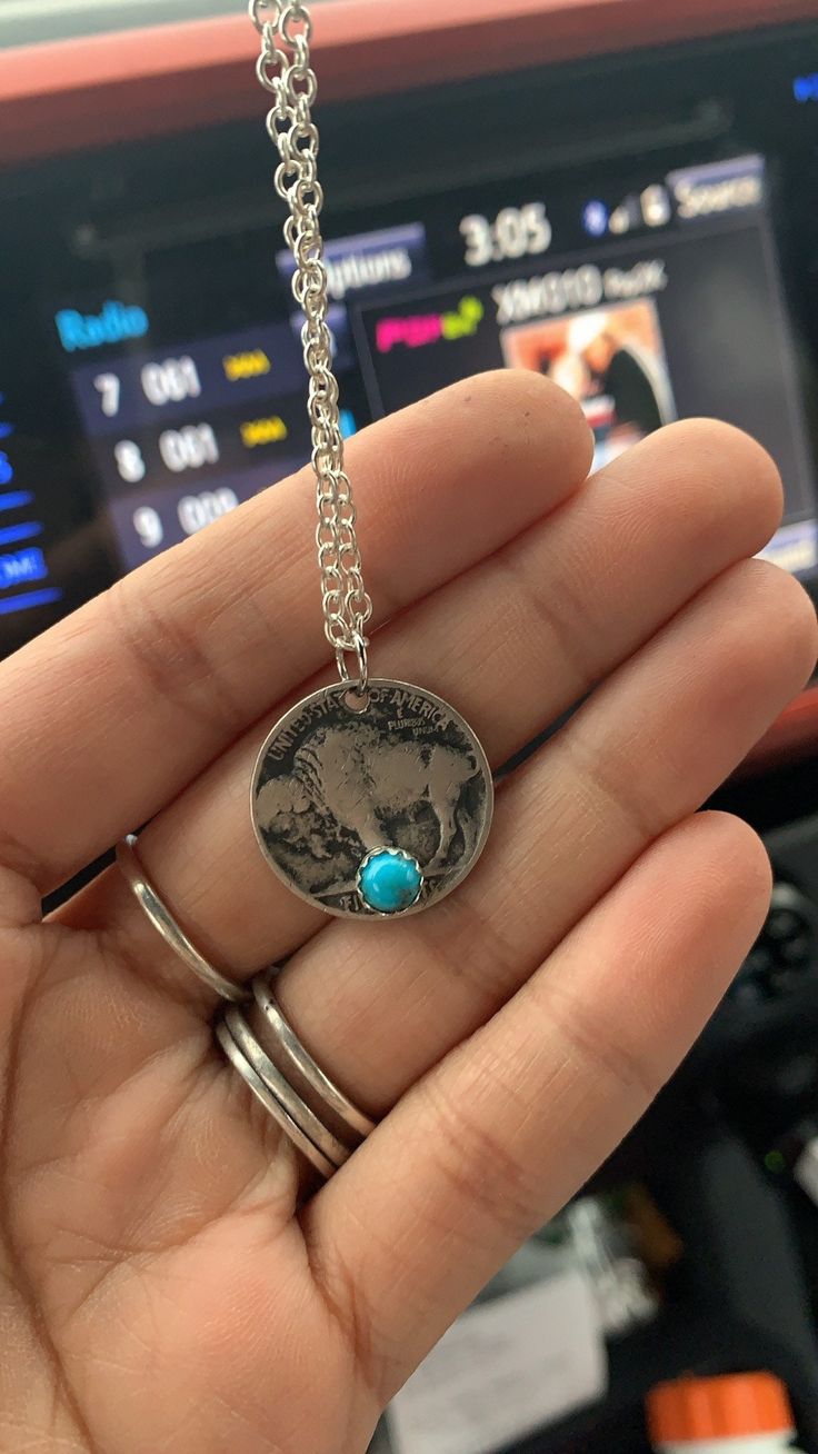 This very cute buffalo nickel is authentic and with a genuine turquoise stone with a sterling silver bezel. Chain length is 24 inches Turquoise Concho Necklace As Gift, Stamped Turquoise Round Jewelry, Stamped Round Turquoise Jewelry, Turquoise Stamped Round Jewelry, Blue Turquoise Concho Necklace As A Gift, Concho Sterling Silver Necklace For Gifts, Sterling Silver Concho Necklace For Gift, Nickel-free Turquoise Necklace With Silver Round Pendant, Nickel-free Silver Turquoise Necklace