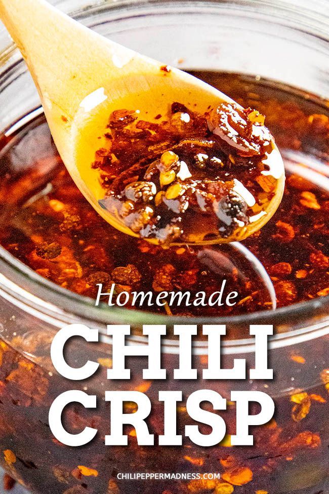 homemade chili crisp recipe in a glass jar with a wooden spoon full of it and text overlay